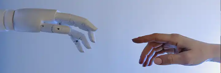 Mano robot y mano humana.